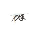 Serpentine 1 dining table made with
  tempered glass top and brass patina finish bronze base – main view
