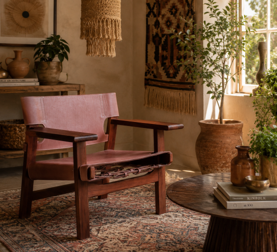 Solid walnut lounge chair styled with woven textiles, indoor plants, and mid-century modern furniture